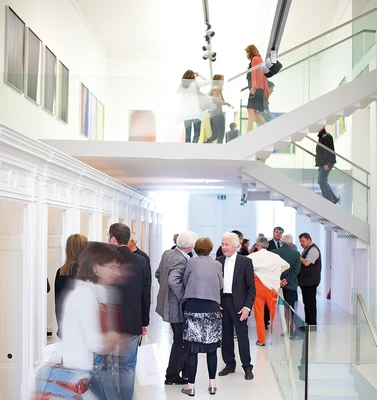 Besucher und Besucherinnen in den Ausstellungsräumen des Arnulf Rainer Museums.