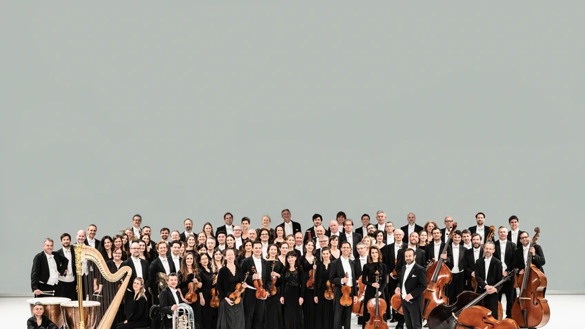 Klassisches Orchester mit Instrumenten vor hellem Hintergrund