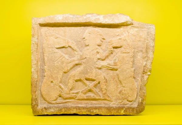 “Horse Tamer” Relief, a stone sculpture depicting two men taming horses