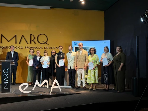 Group of award recipients on stage during an award ceremony.