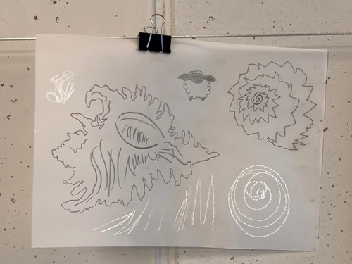 Botanical drawings on slightly transparent paper, hanging from a metal cord with a clip.