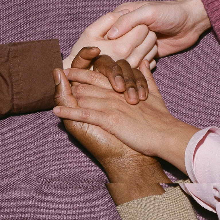 The theme for the Festspielhaus’s 2026/2027 season. The image shows hands gently touching, set against a soft, textured purple background.