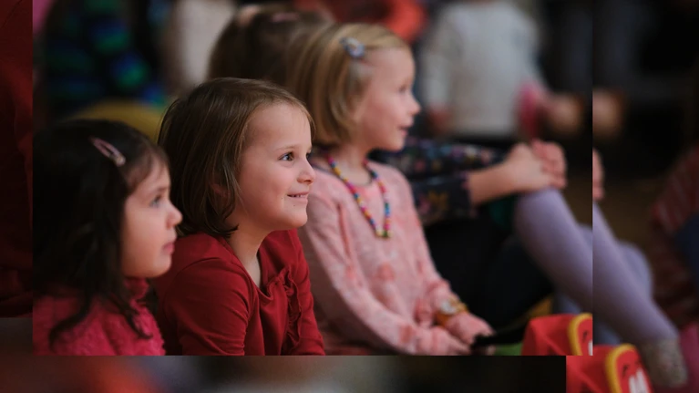 Audience photo from the ‘Tonspiele’ project ‘Schnee’ (Snow) – a project of the music education programme of the Tonkünstler Orchestra Lower Austria. The photo shows happy children listening and watching intently.