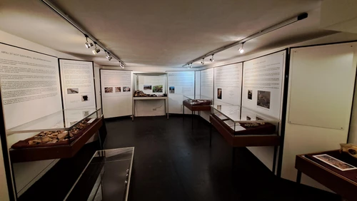 View of the exhibition space at the Auxiliary Fort Museum, display cases, and posters 