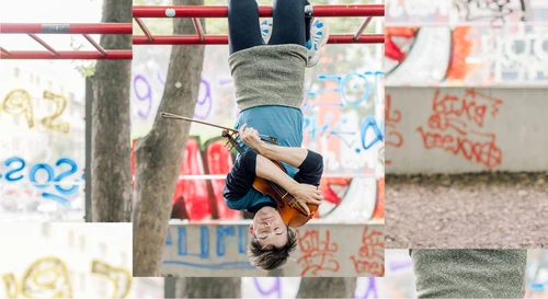 Foto für die Performance "Fledermäuse", zu sehen ist ein:e Künstler:in des Kollektivs "schallundrauch agency" der:die kopfüber von einem Klettergerüst hängt, mit den Armen eine Geige fest umschließend.Foto für die Performance "Fledermäuse", zu sehen ist ein:e Künstler:in des Kollektivs "schallundrauch agency" der:die kopfüber von einem Klettergerüst hängt, mit den Armen eine Geige fest umschließend.v