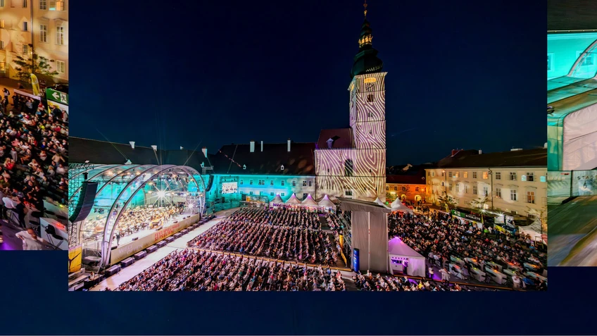 Photo of the Domplatz Open-Air concert featuring the Tonkünstler Orchestra – the stage can be seen on the left-hand side of the picture, along with the large crowd gathered against the backdrop of St. Pölten Cathedral.