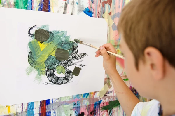 Children paint colorful pictures and create works of art in the art studio.
