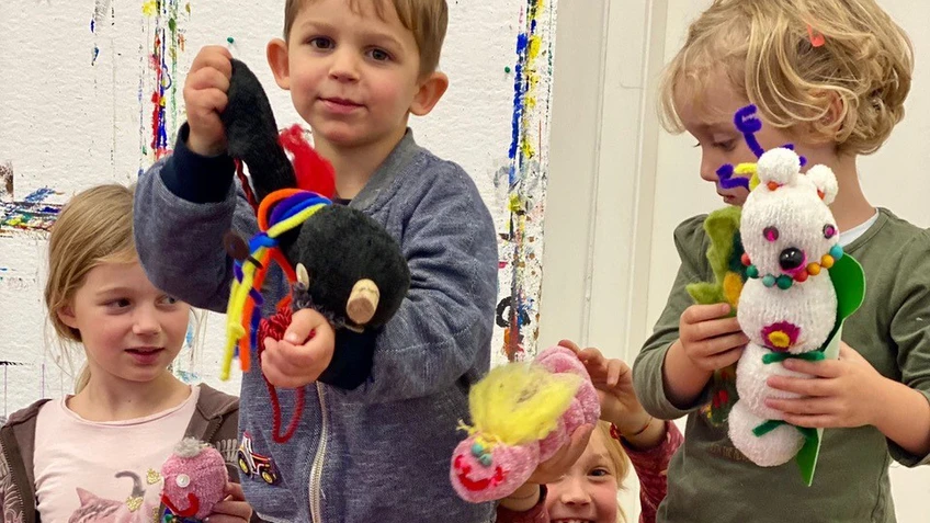 Kids with dolls made out of socks