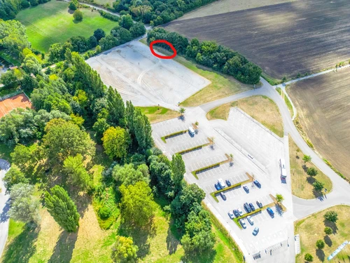 Aerial view of the large parking lot with the motorhome parking area marked in the form of a red circle