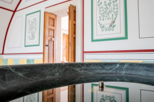 New spa room; in the foreground, a water basin with the reflection of the mural in the background