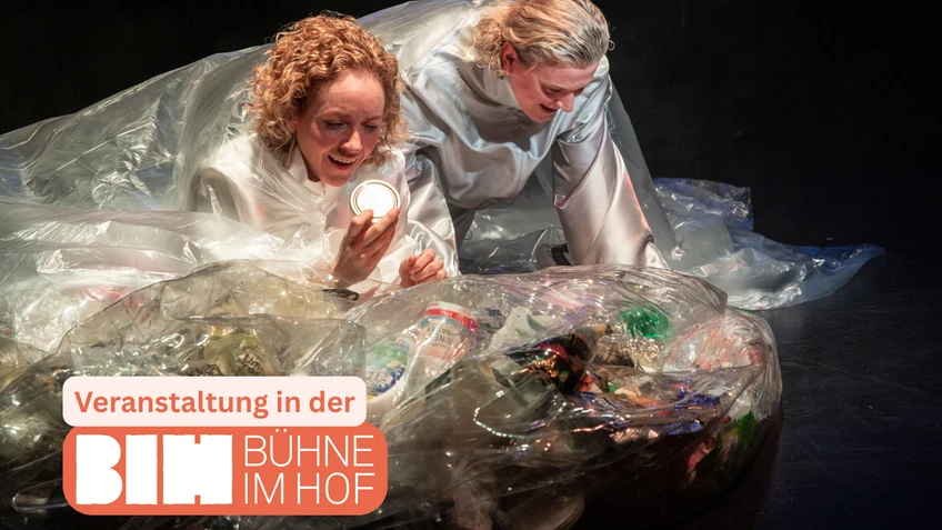 Set design from the children's performance of Moby Dick – with two actors in a small landscape made of reflective foil, which also contains plastic waste.