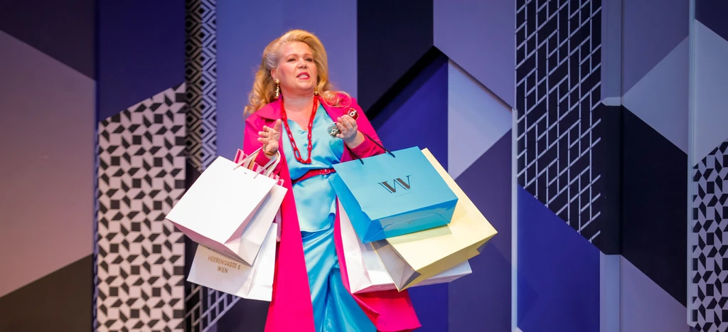 Lady with a blue dress and pink cape holding some shopping bags - background is blue with abstract pattern