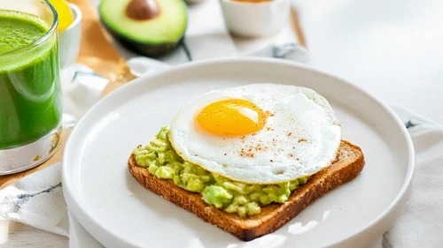 Breakfast with acocado toast and fried egg and green smoothie